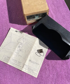 NOS black underseat tissue dispenser for 1970s Chevrolet Impala Caprice pickup truck bench seat part number 994664 OEM accessory