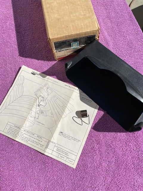 NOS black underseat tissue dispenser for 1970s Chevrolet Impala Caprice pickup truck bench seat part number 994664 OEM accessory