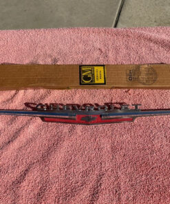 Close-up of 1962 Chevrolet Chevy II Nova hood lip emblem part number 3792812 original NOS chrome trim piece