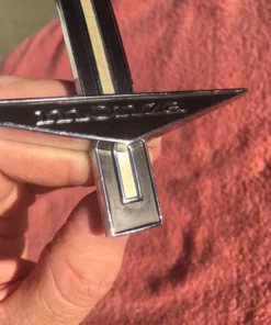 1964 Chevrolet Corvair Monza front fender emblem part number 3839504 original GM trim piece in excellent used condition for classic Corvair restoration projects.