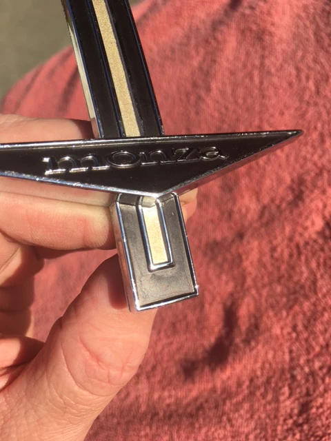 1964 Chevrolet Corvair Monza front fender emblem part number 3839504 original GM trim piece in excellent used condition for classic Corvair restoration projects.