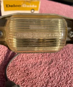 Alternative view of 1966-1971 Chevrolet NOS Delco GUIDE License Plate Lamp Lens Assembly #910967